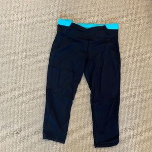 Calvin Klein Cropped Athletic Leggings. Black with blue band at the top.
